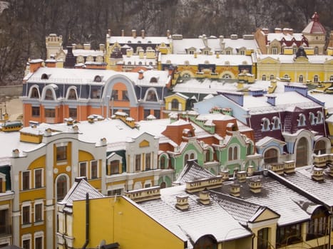 Roofs of restored buildings covered with snow