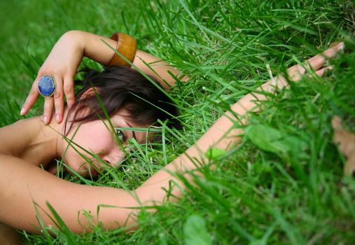 The girl in a grass. The face close-up