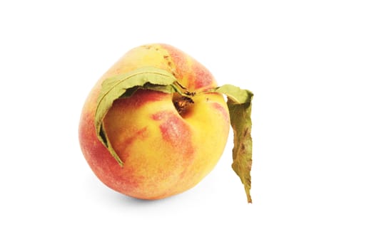 ripe fresh peach with leaves over white