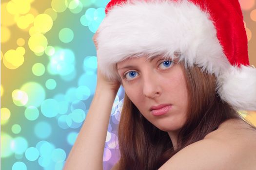 The nice girl on the eve of new year sitting in a red cap