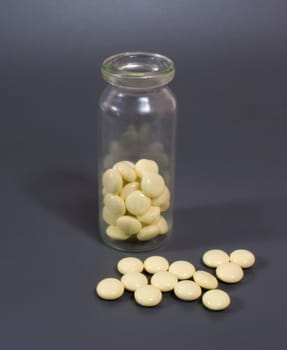 group of yellow pill in the glass vial