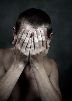 The sad man closed the face hands