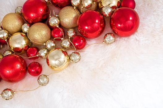 Elegant Christmas baubles with stars, angels and gold ribons on a slightly textured reflective surface
