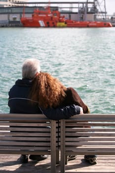 Elderly the man with the young girl in port