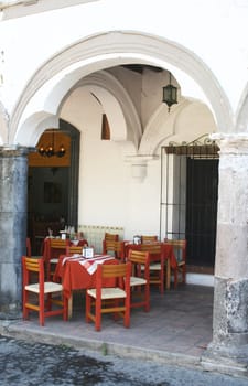 restaurant tables under arch in mexico