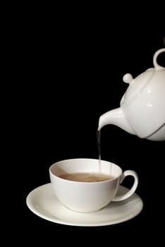 tea, pouring from a white china pot into a white china cup