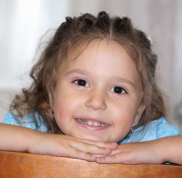 It is a photo of the little girl in a blue dress with curly long hair. It very beautiful.