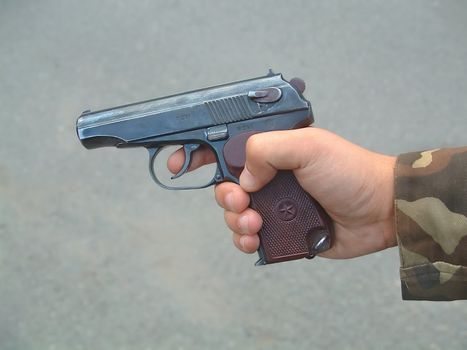 The image of the fighting weapon of system Makarova in a hand of the soldier
