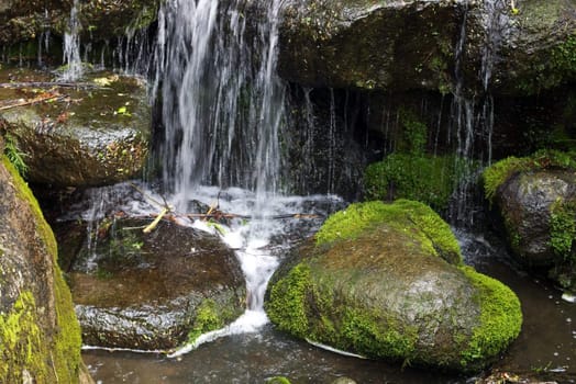 scenic waterfall with the heart-shaped stone