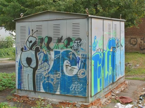 The image of old electric substation the ornamented youth in style "graffiti"
