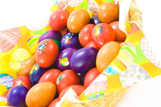 Basket full of colorful easter eggs. Isolated.