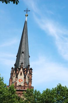 Church clock tower against bright blue sky