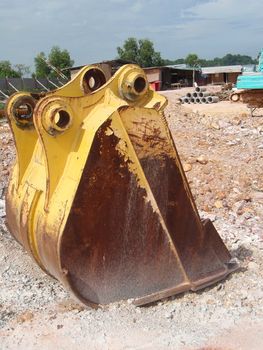 A closeup image of an excavator bucket delivered to a building site.