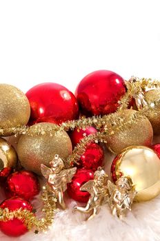 Elegant Christmas baubles with stars, angels and gold ribons on a slightly textured reflective surface