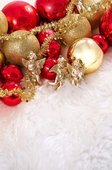 Elegant Christmas baubles with stars, angels and gold ribons on a slightly textured reflective surface