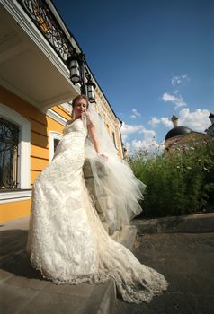 The beautiful bride on a background of a private residence