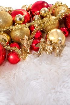 Elegant Christmas baubles with stars, angels and gold ribons on a slightly textured reflective surface