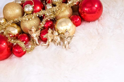 Elegant Christmas baubles with stars, angels and gold ribons on a slightly textured reflective surface