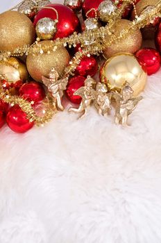 Elegant Christmas baubles with stars, angels and gold ribons on a slightly textured reflective surface