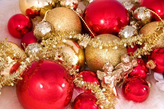 Elegant Christmas baubles with stars, angels and gold ribons on a slightly textured reflective surface