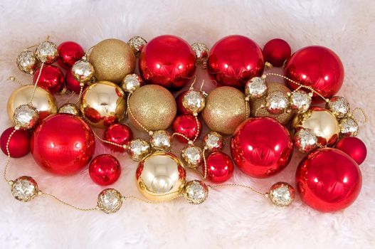 Elegant Christmas baubles with stars, angels and gold ribons on a slightly textured reflective surface