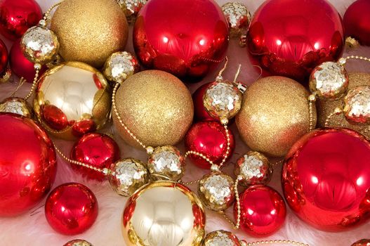 Elegant Christmas baubles with stars, angels and gold ribons on a slightly textured reflective surface