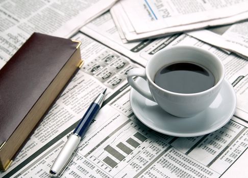 Cup of coffee on the newspaper