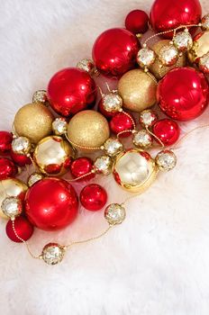 Elegant Christmas baubles with stars, angels and gold ribons on a slightly textured reflective surface