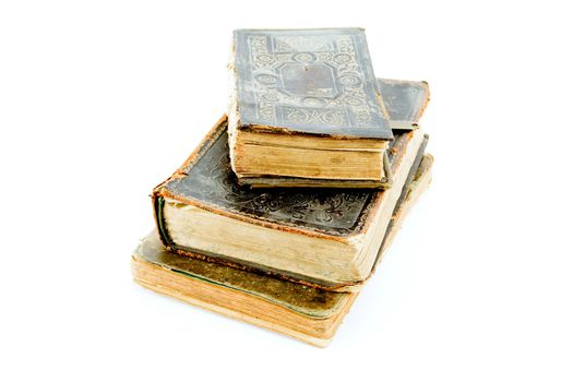 Three closed old books lying one on another. Isolated on white.