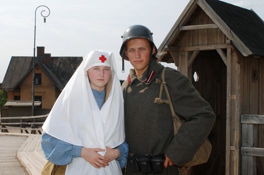 Old style picture with woman in nurse costume and man in soldier uniform. Costumes are authentic to the ones weared in time of  World War I.