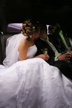 Kiss of a newly-married couple in car