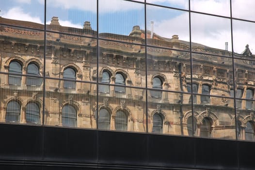 Reflection of an old architecture on glass window