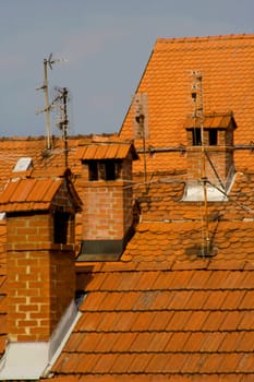 Red roofs and chimneys in the center of old city.