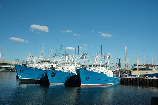 Ships at harbor with blue sky