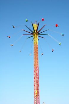 Swinging ride against blue sky at the amusement park