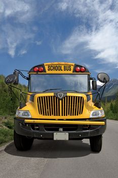 Front view of a school bus on a rural road.