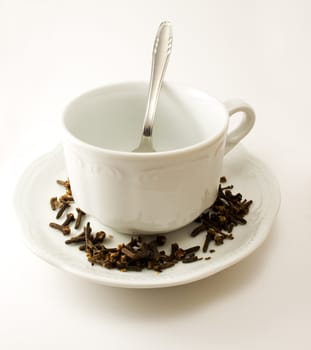 Empty tea cup with saucer, decoration and spoon