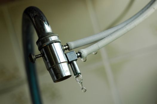 A old dripping tap. Don't waste water.