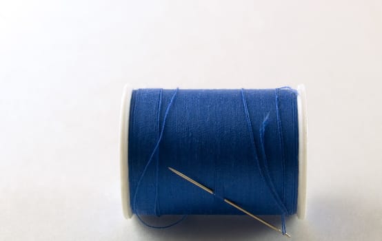 Blue Thread and needle ready for sewing.