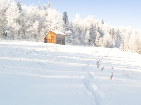 Wooden cottage. Winter time in mountain. White snow