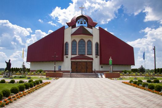 Big modern church in Poland. Sunny summer day. Blue sky.