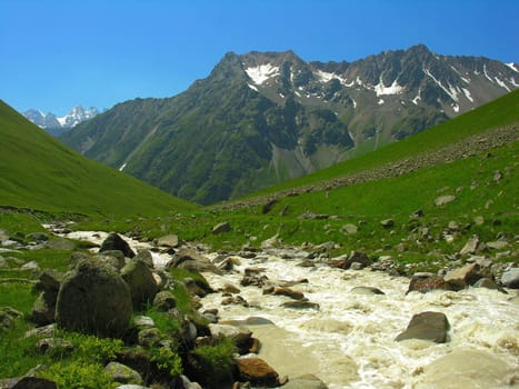 The mountain river current on a valley          