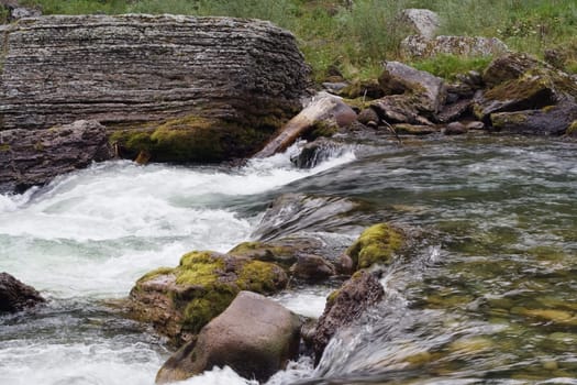 green water and stones in the stream 
