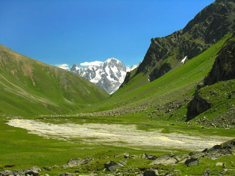  Mountain valley on a background of the blue sky         