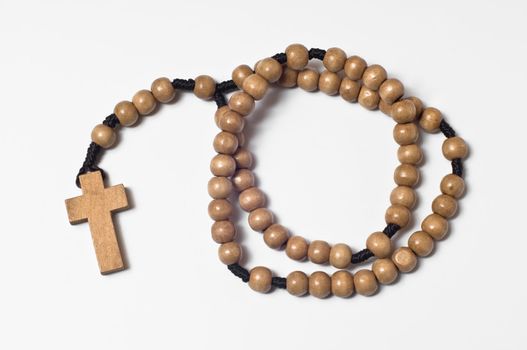 wooden rosary beads on white background
