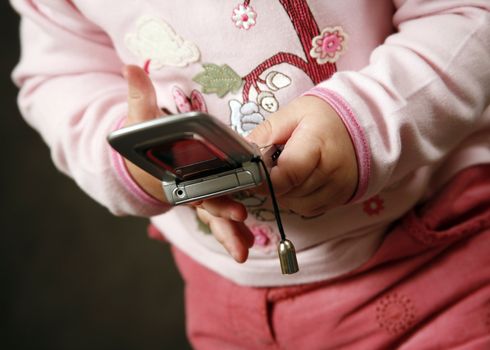 Baby's hands playing with cell phone