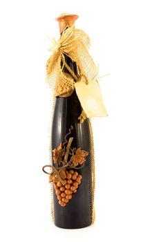 Decorated bottle of wine with grapes on it. Isolated on white background.