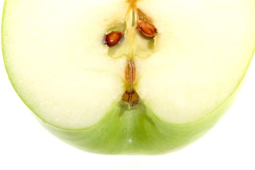 Part of the cut green apple with seed on white background