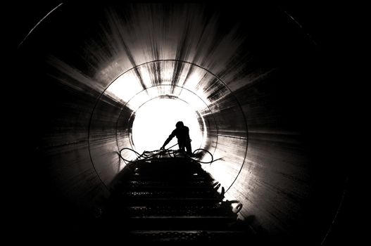 Image from inside tube looking out at a worker