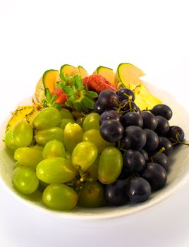 Plate full of fruit, isolated on white background.